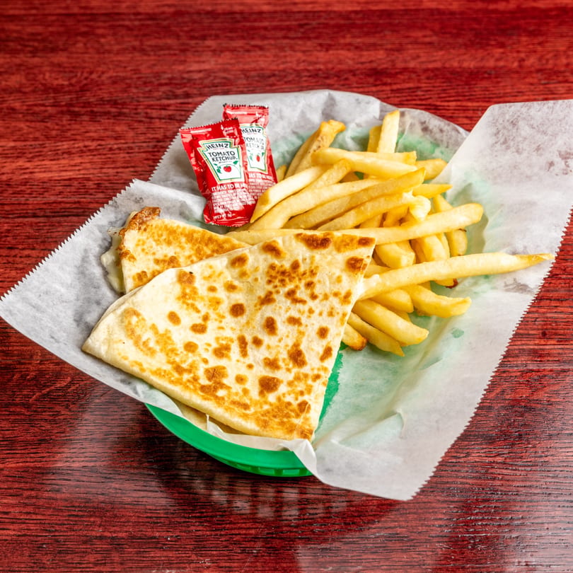 Nally's Kitchen quesadilla and french fries with Heinz ketchup packets in a green basket.